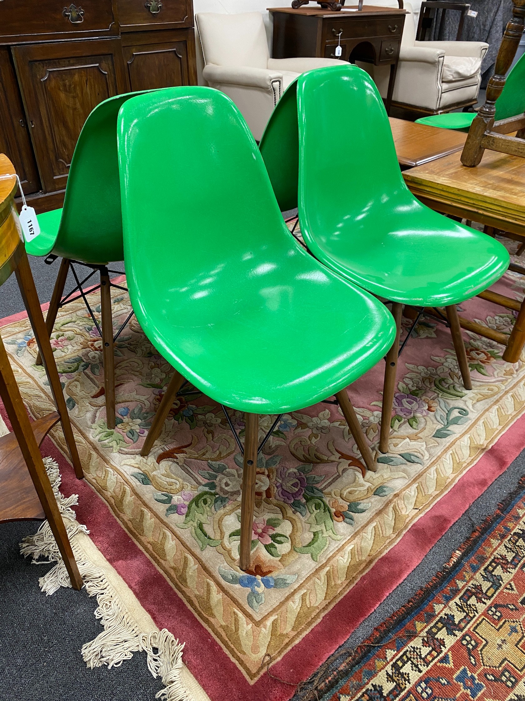 A set of six green Eames chairs